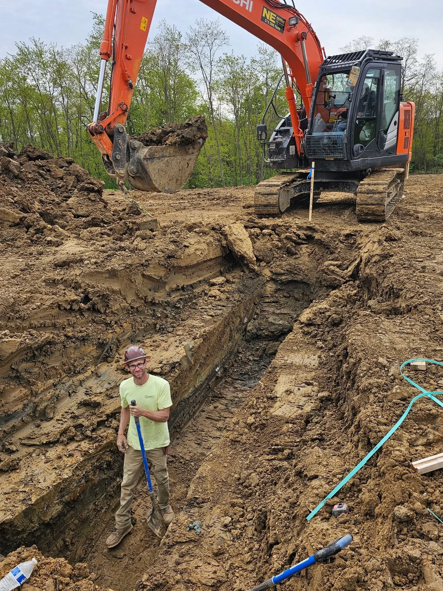 Cliff Contracting excavator and crew working in a utility trench