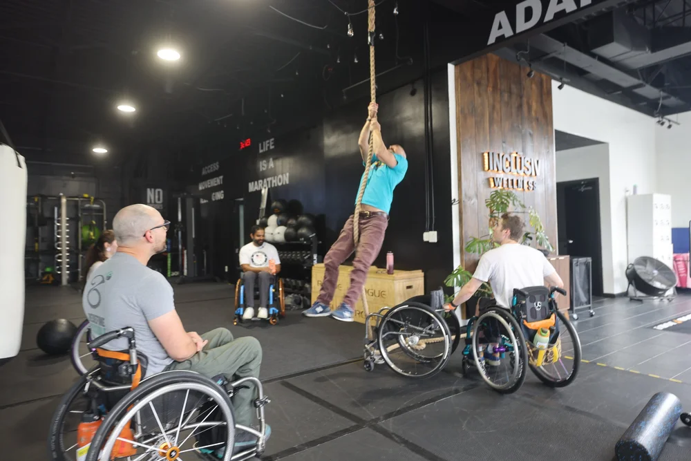 A member climbing the rope during a group session