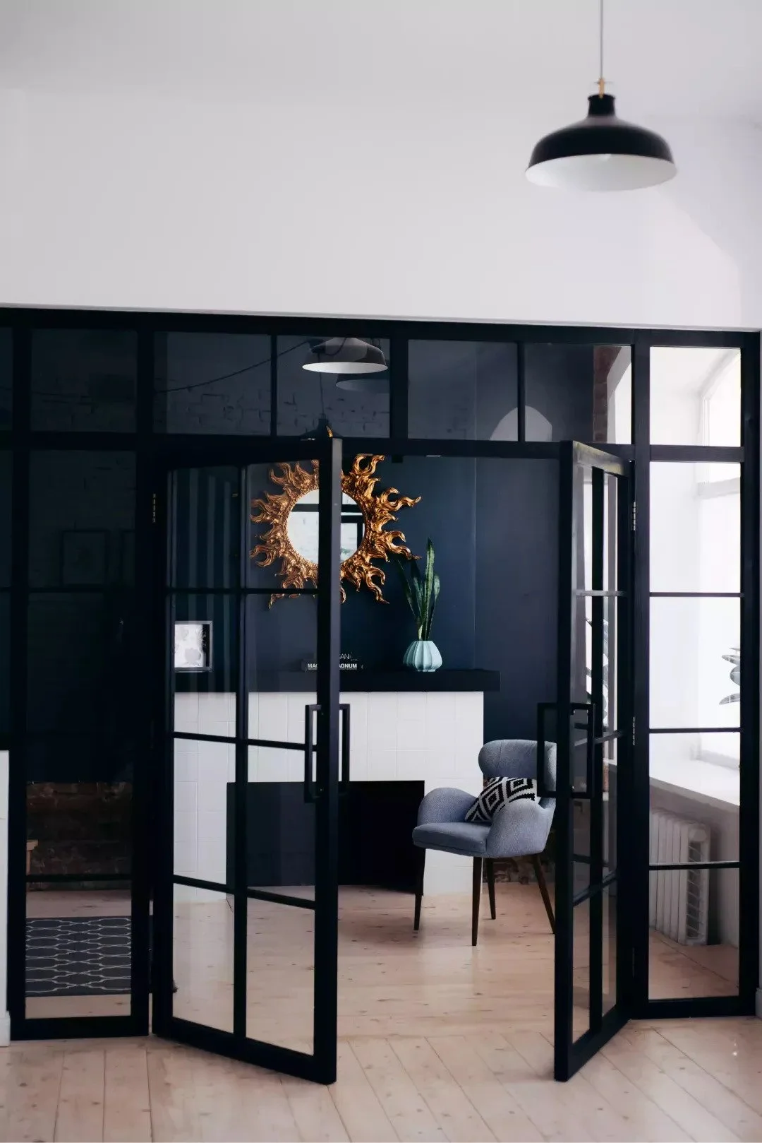 Modern office with matte walls and black-framed glass door