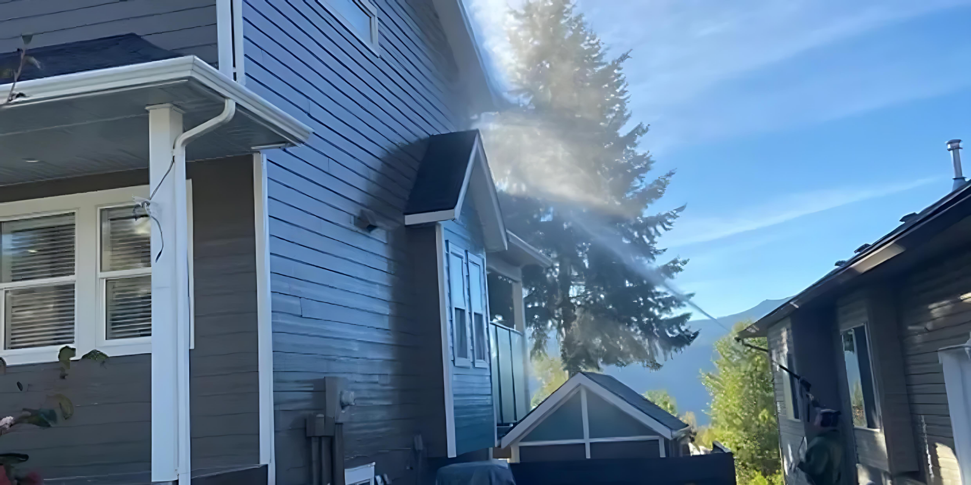 Tech soft-washing a home exterior