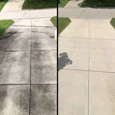 Driveway: dark, stained concrete versus bright, even finish after cleaning