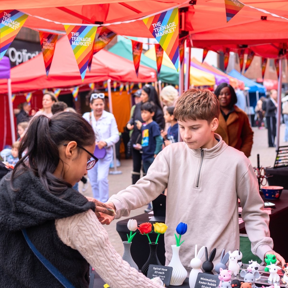 Young trader serving a customer at the Nuneaton Teenage Market