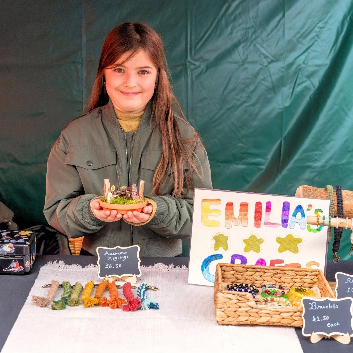 Young trader displaying handmade products in Nuneaton