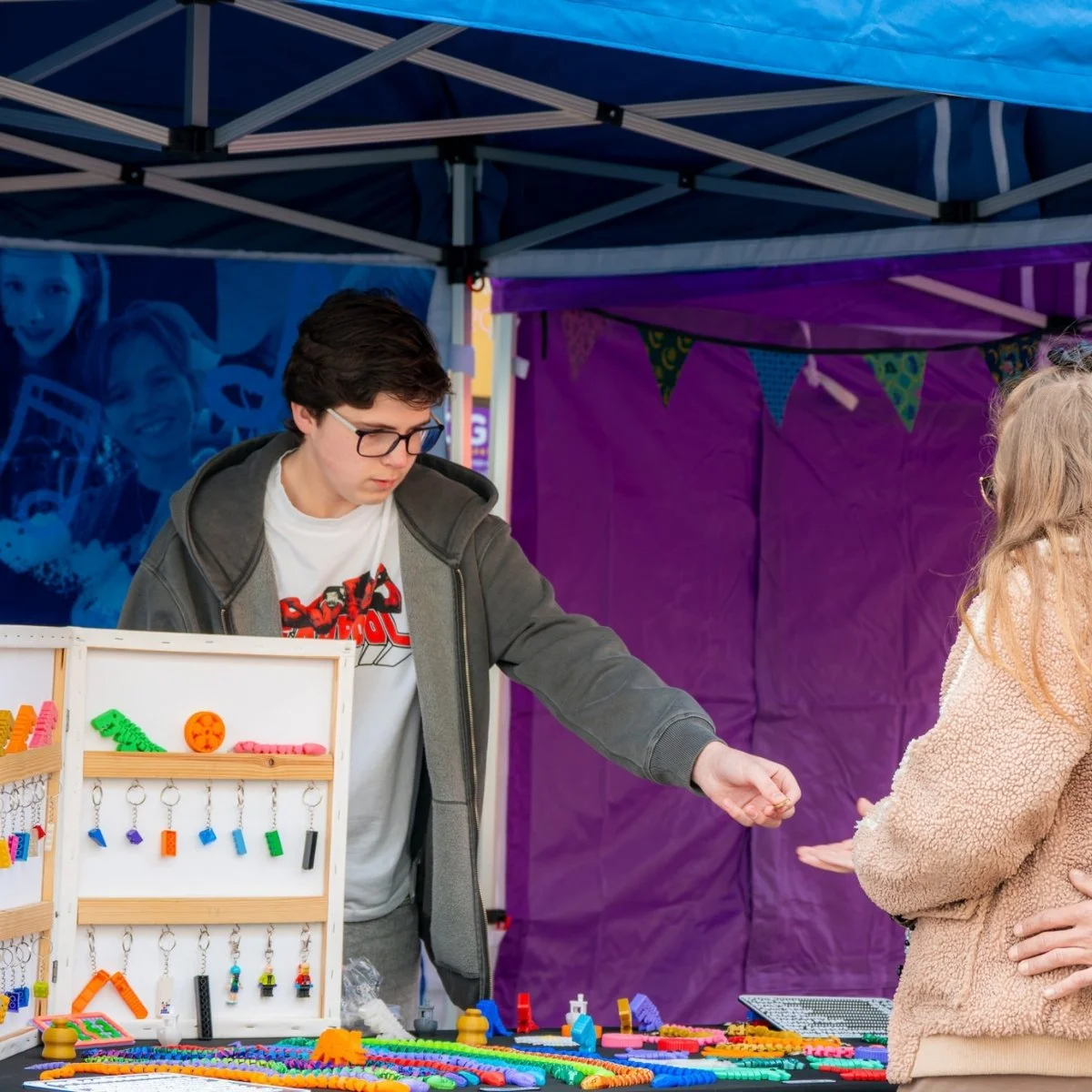 Young trader completing a sale at the Nuneaton Teenage Market