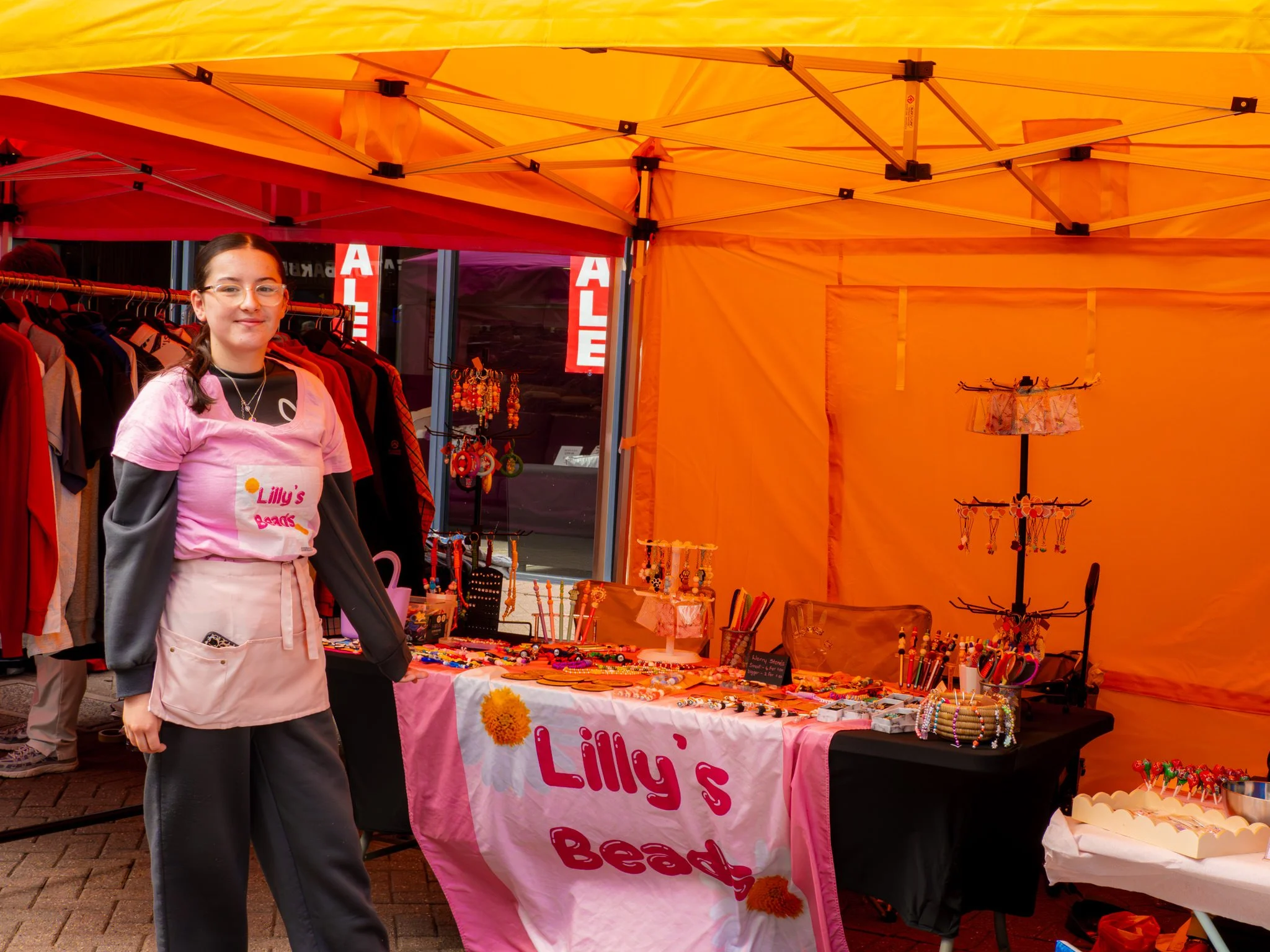Young trader beside her stall at Nuneaton Mark It