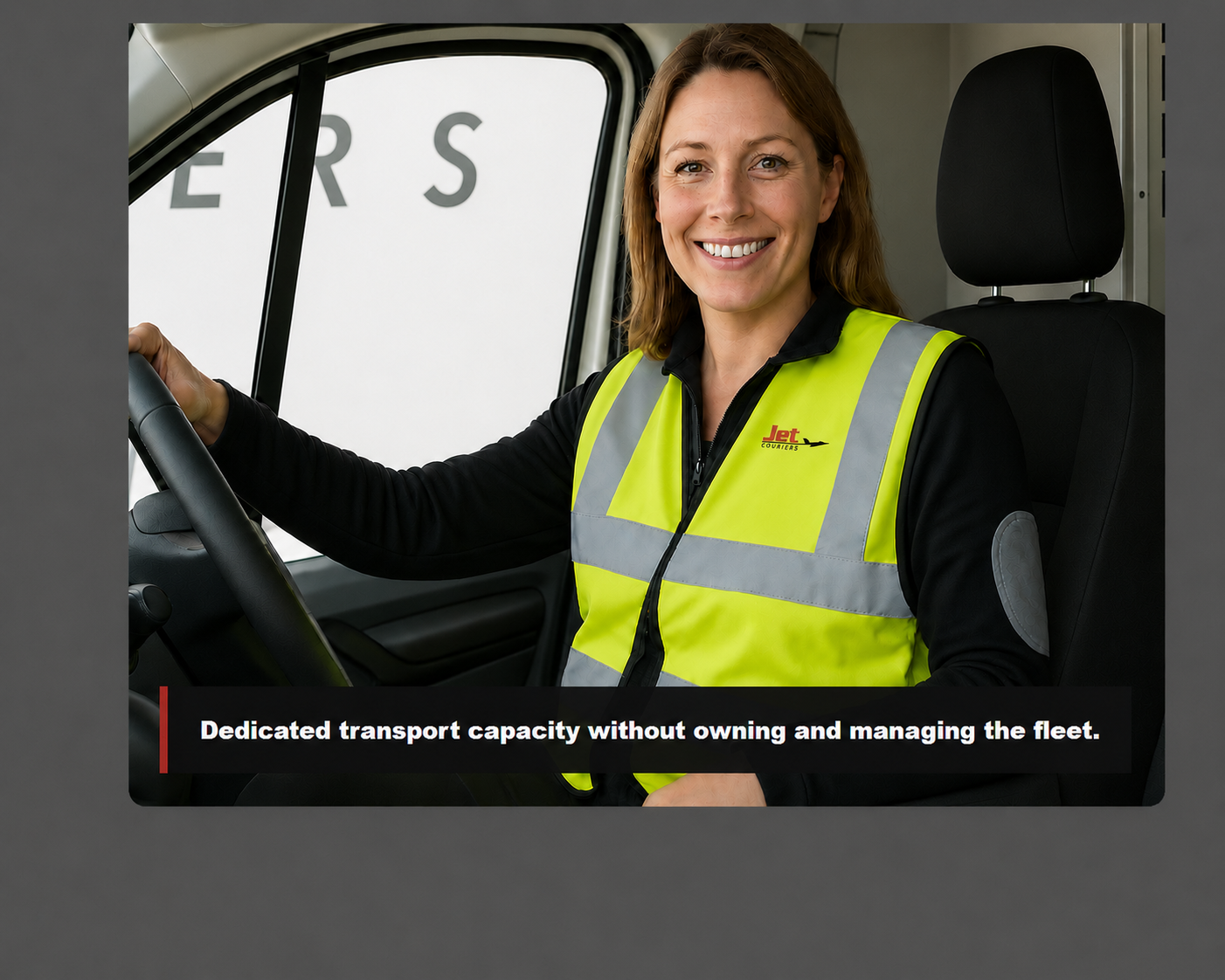 Smiling Jet Couriers driver wearing a correctly branded high-visibility vest