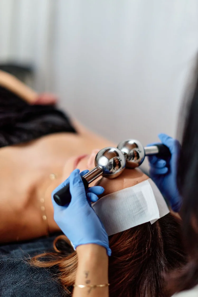 Hazel using cooling facial globes during a corrective facial