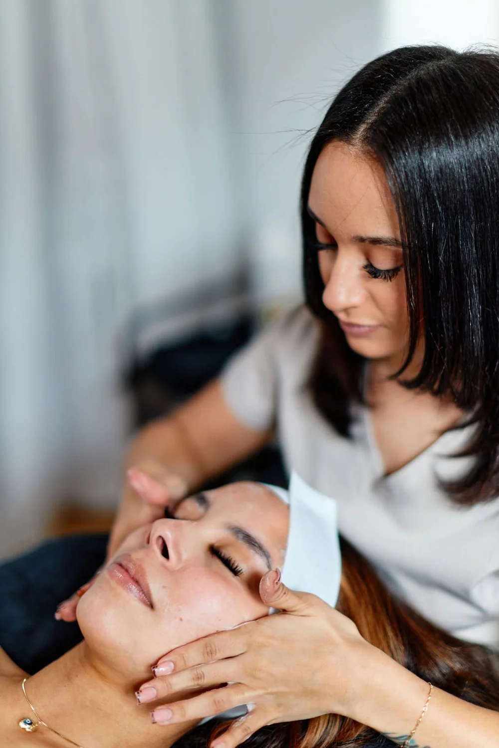 Hazel performing a corrective facial treatment