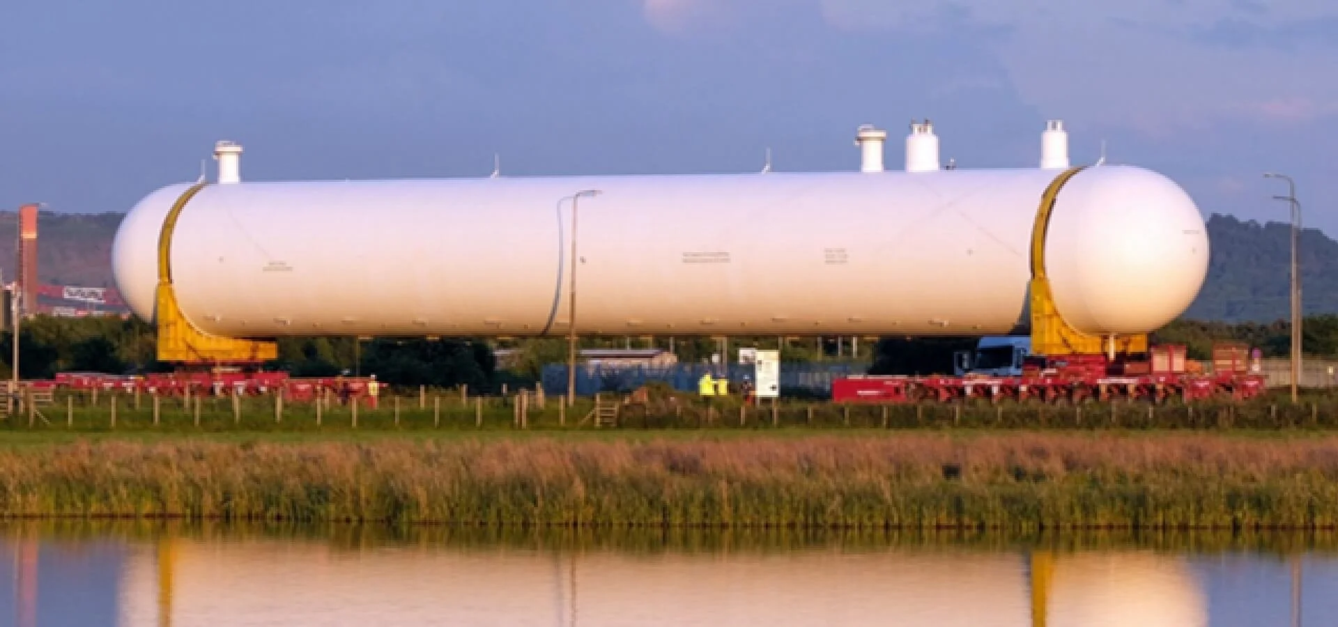Large cylindrical vessel mounted on a multi-axle abnormal-load transporter at Seal Sands in Teesside.
