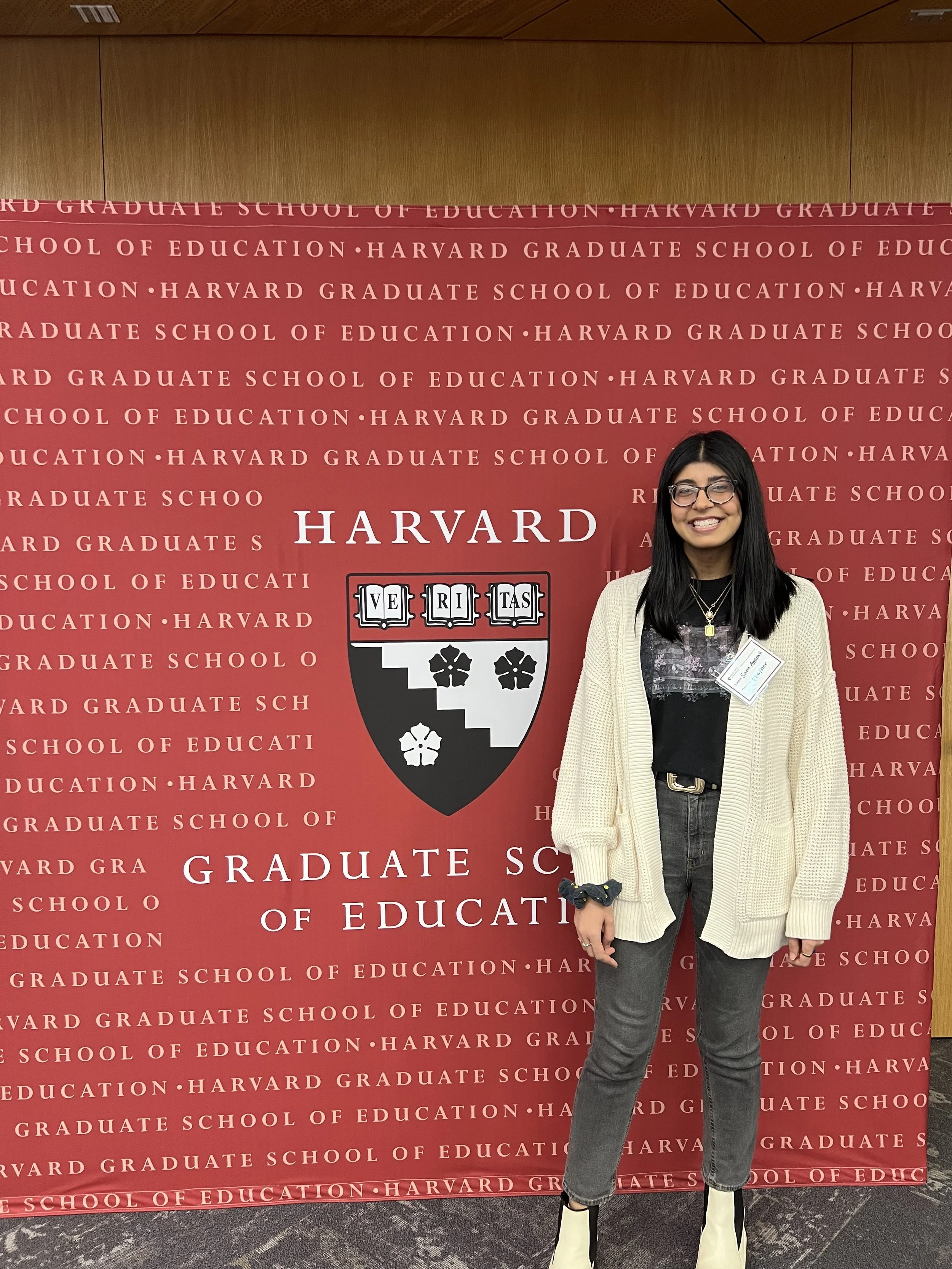 Posing in front of the Harvard Graduate School of Education banner