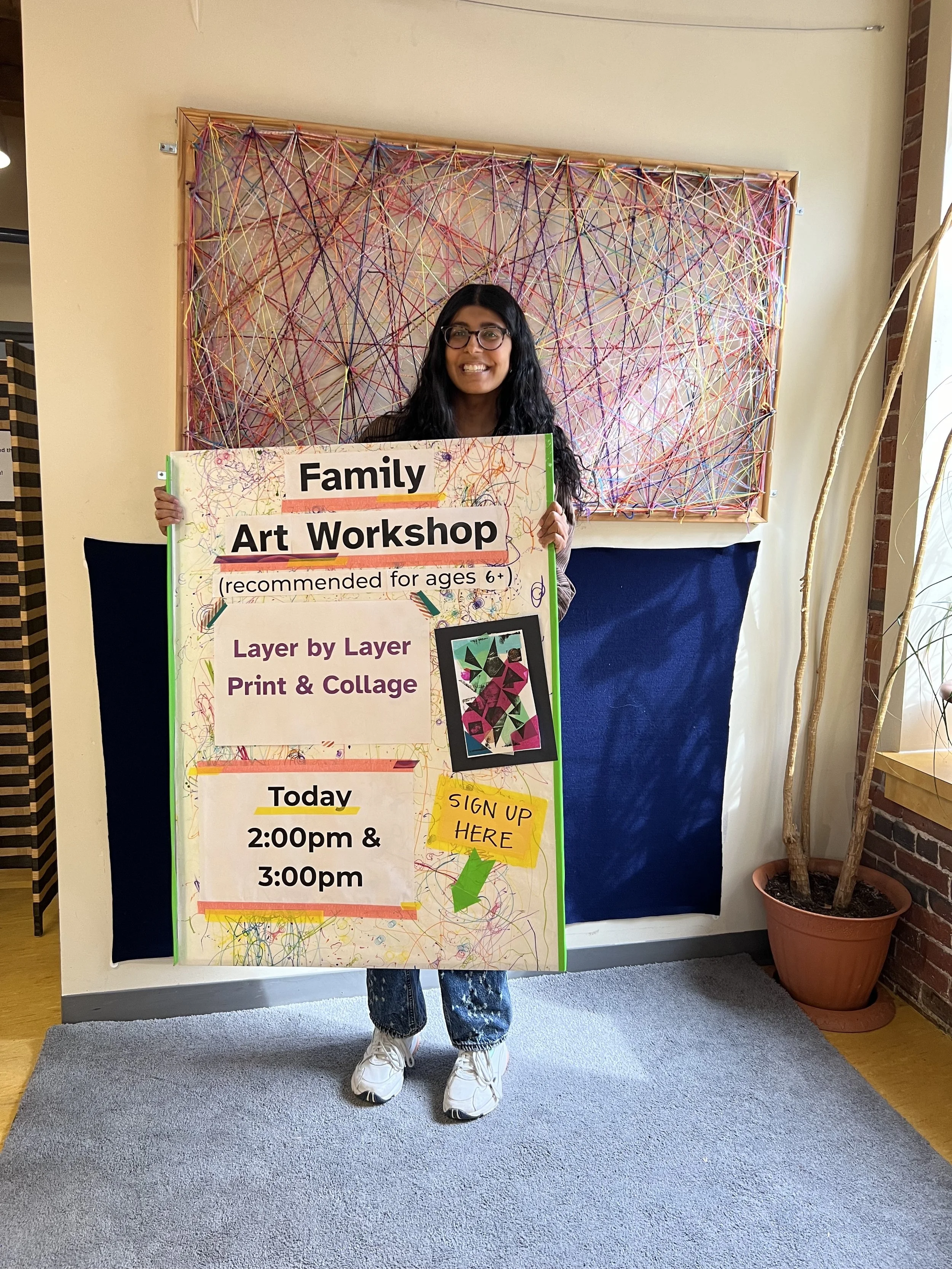 Holding the sign advertising my workshop at the BCM Art Lab