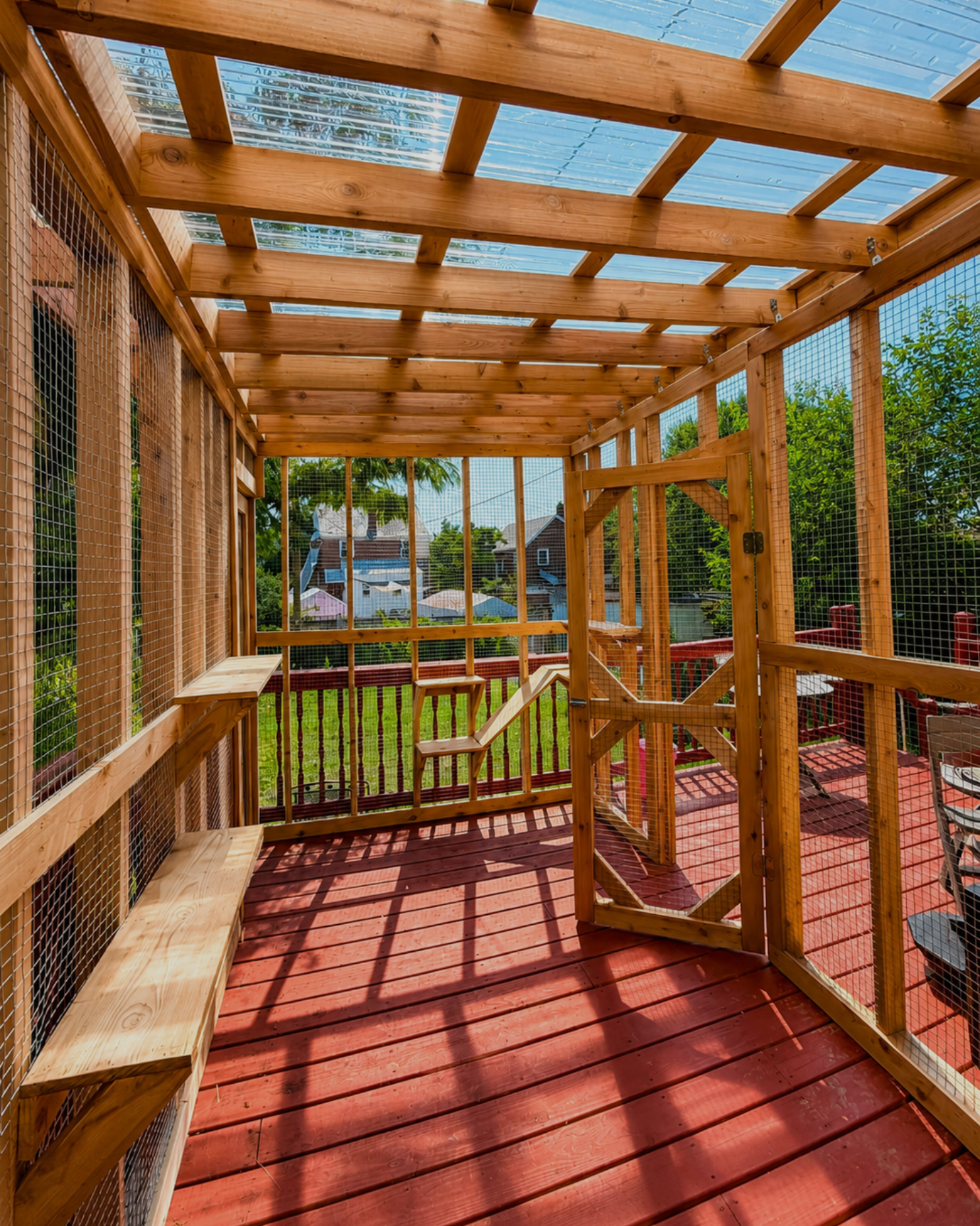 Cedar deck catio with clear roof panels, designed and built by Monument Catios