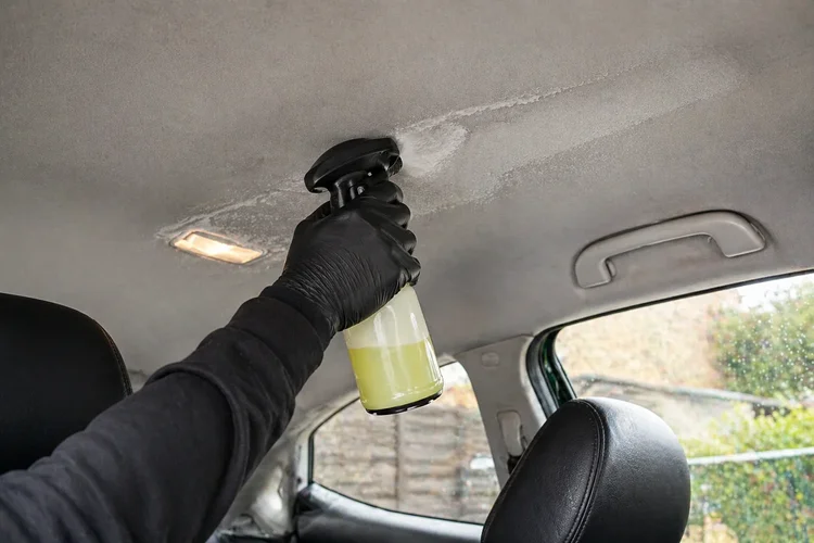 Enzyme cleaner sprayed onto vehicle headliner
