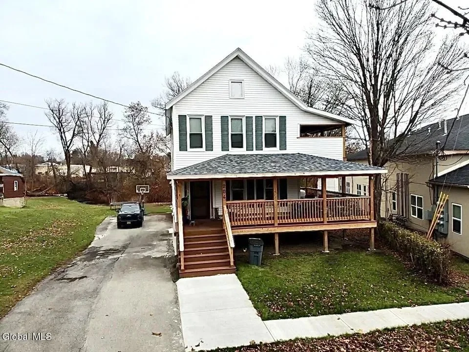 Front porch and exterior of the sold home at 204–206 Wells Street in Johnstown, New York