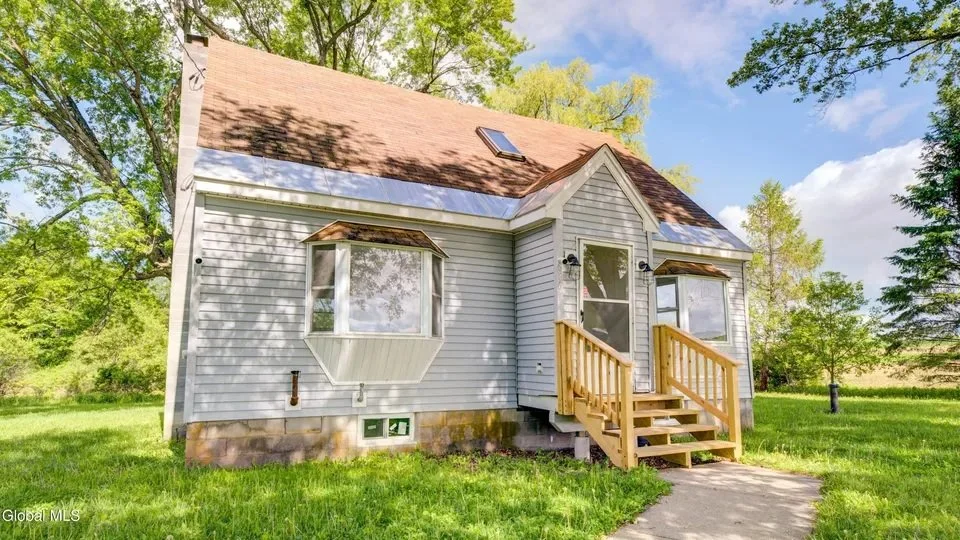 Cape Cod home and lawn at 886 Old Sharon Road in Canajoharie, New York