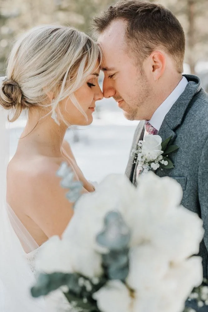 Couple sharing an intimate forehead-to-forehead moment on their wedding day