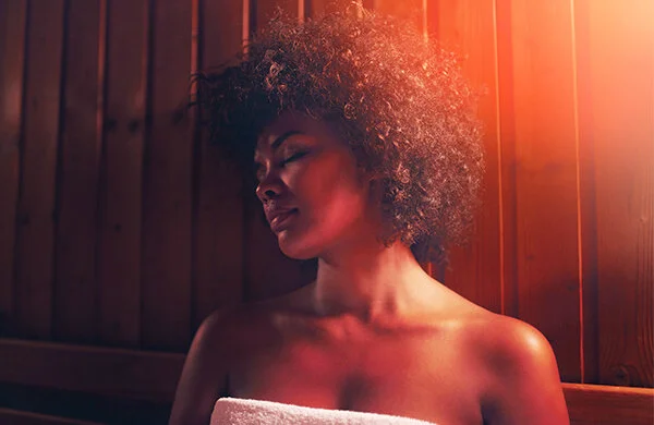 Woman relaxing in an infrared sauna