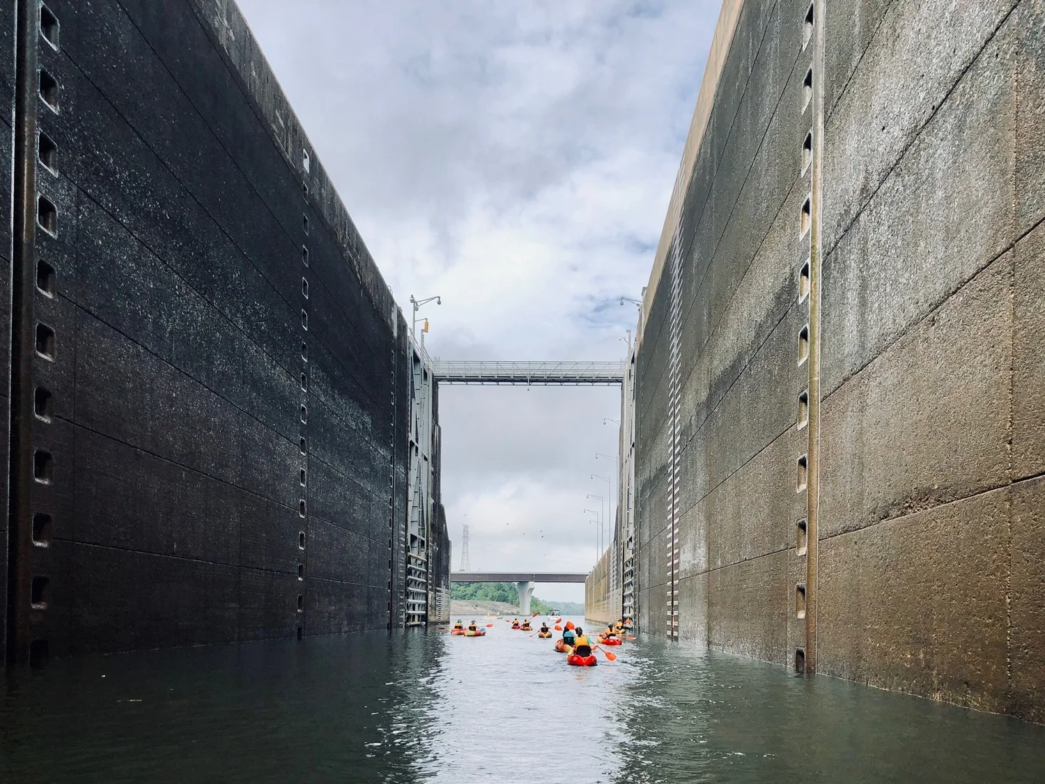Paddlers locking through a dam along the river