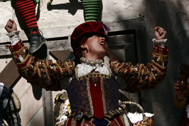Performer with arms raised