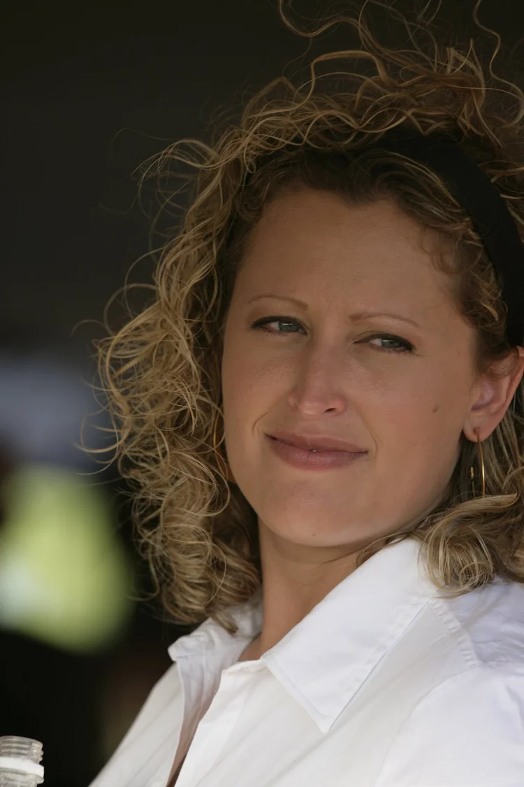 Woman with curly hair in a white shirt