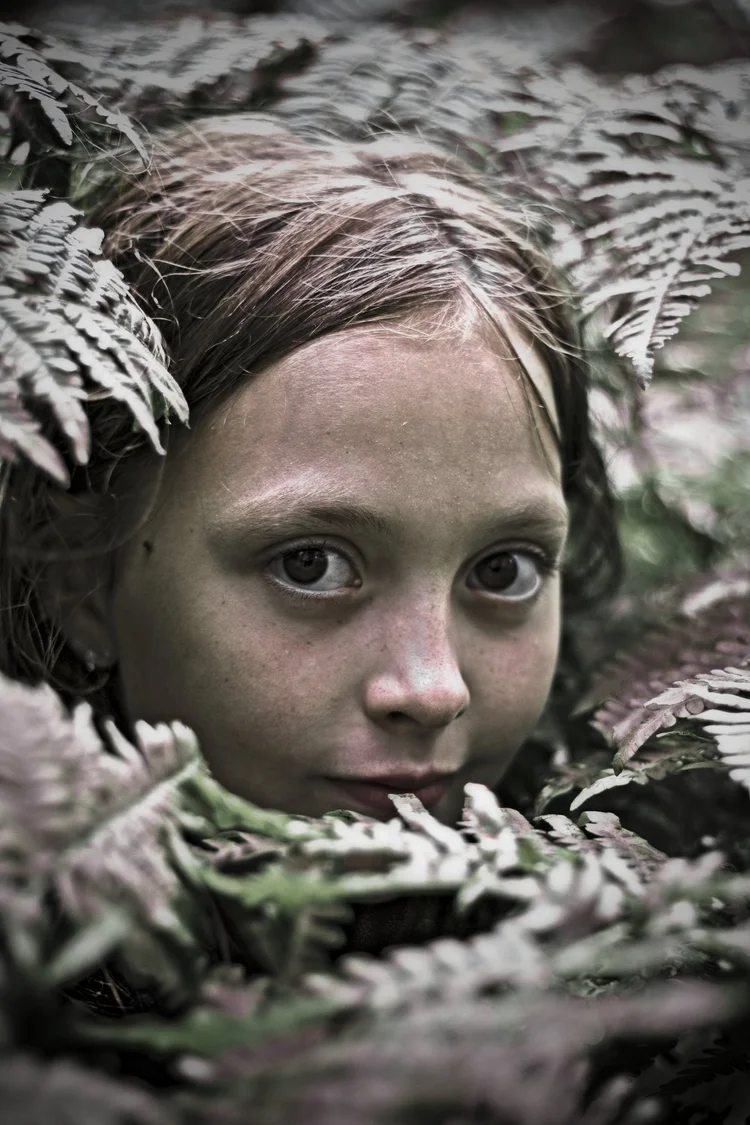 Girl among ferns