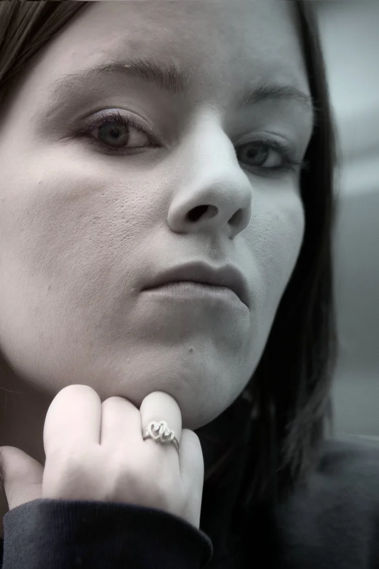 Woman with her hand at her chin, black and white