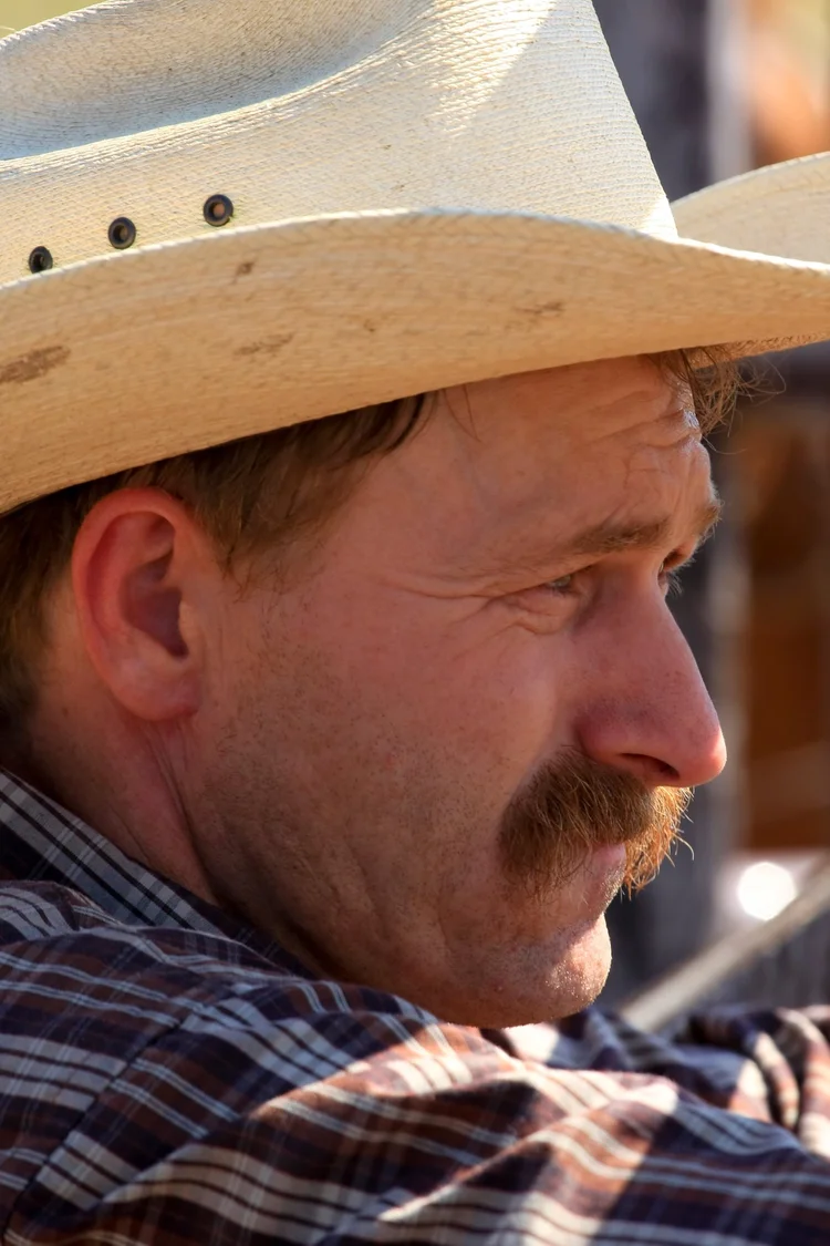 Man in a straw cowboy hat, in profile