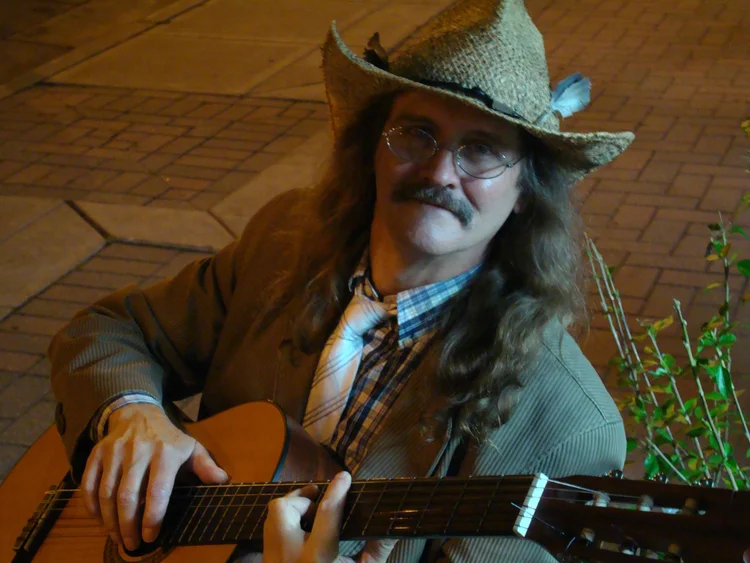 Guitarist in a feathered hat