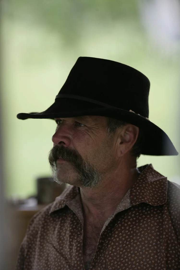 Man in a black cowboy hat