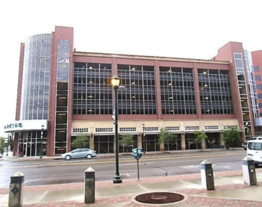 Multi-level parking garage in Colorado Springs with a red and tan facade