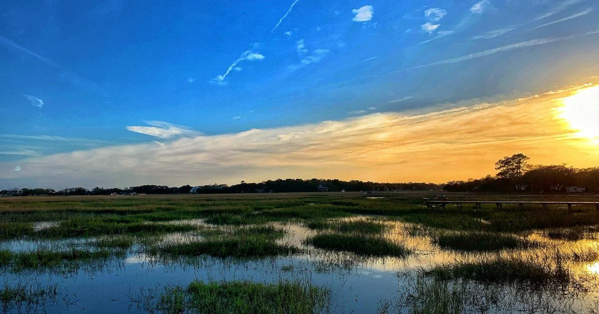 Sunset over the salt marsh and tidal pools on James Island, South Carolina