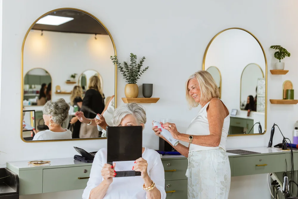 Stylist working with a client at her station