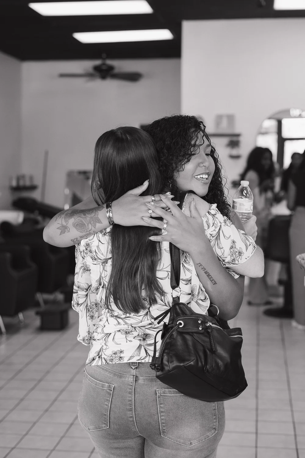 Stylist and client sharing a hug after an appointment