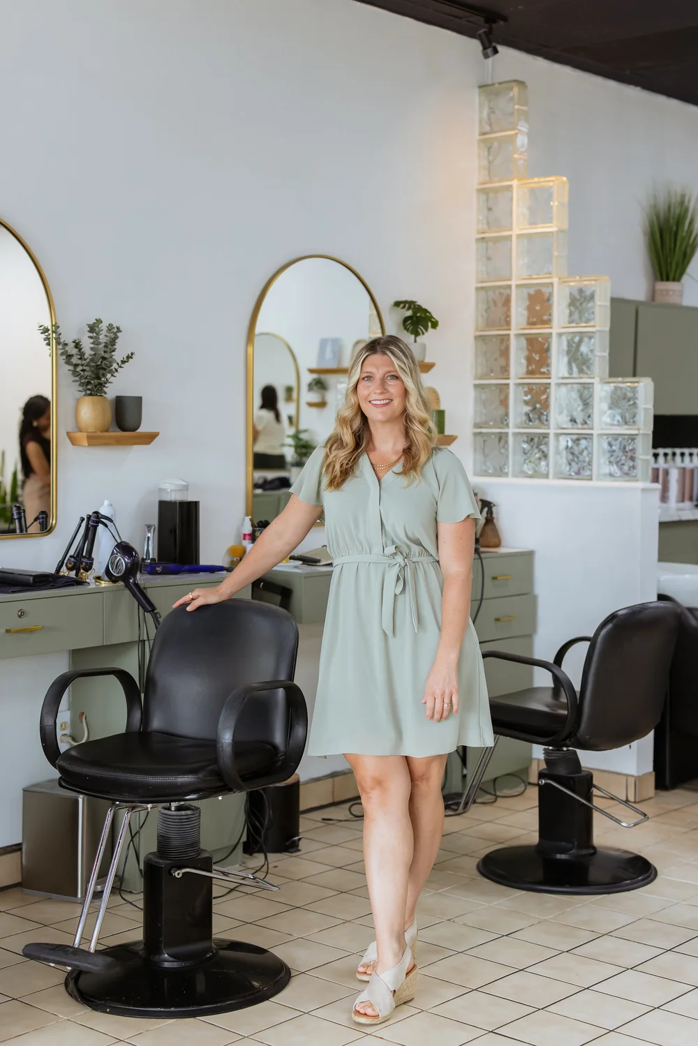 Bright, renovated salon floor with arched mirrors
