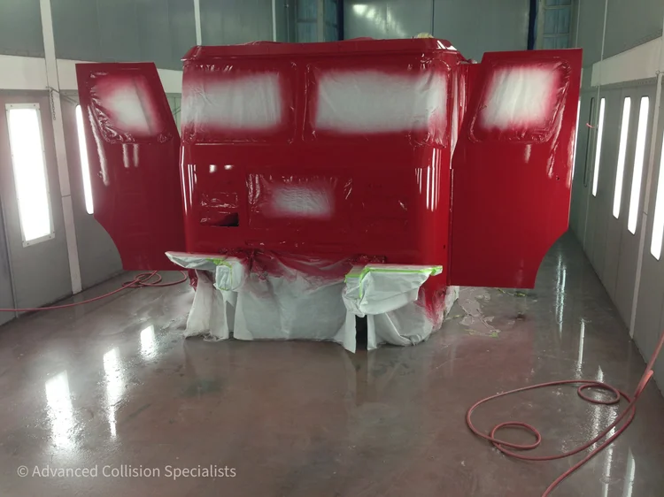 Fire truck cab freshly painted red in the spray booth – Advanced Collision Specialists, Burleson TX