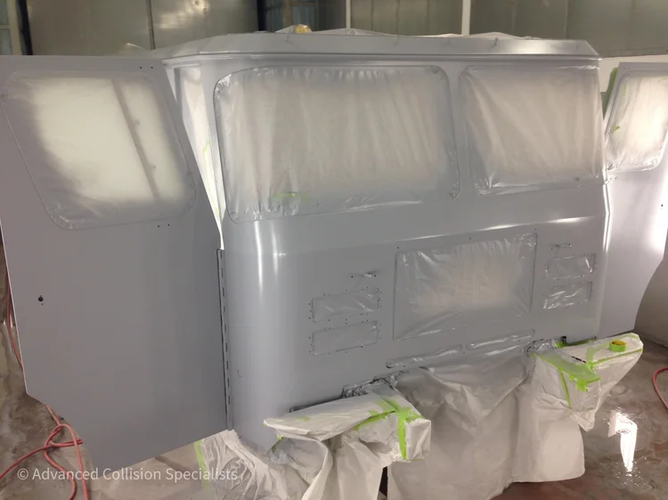 Fire truck cab masked and primed in the paint booth – Advanced Collision Specialists, Burleson TX
