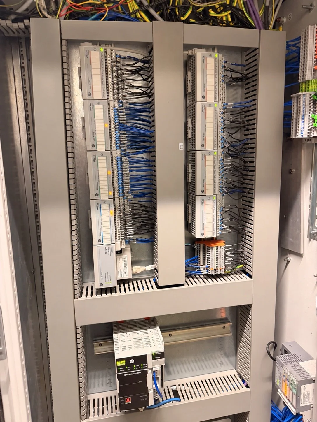 Allen-Bradley CompactLogix controller and FLEX I/O modules inside a water-treatment control cabinet.