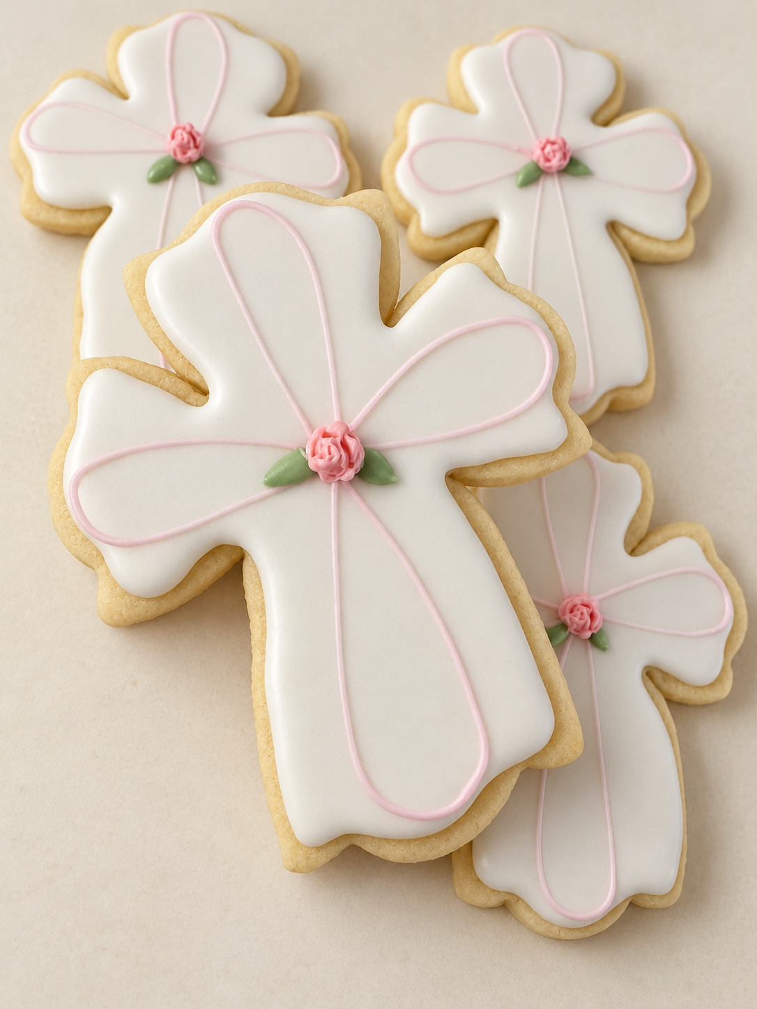 Floral cross sugar cookies with pale pink piping and rose details