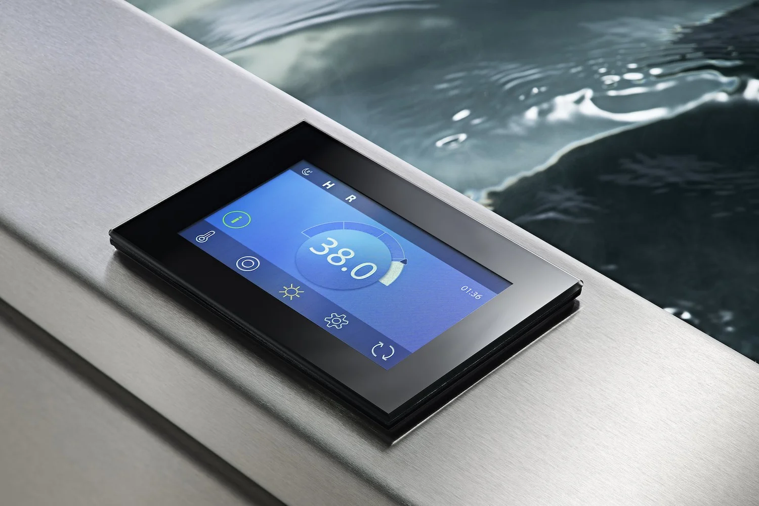 The touchscreen control panel on the rim of the tub