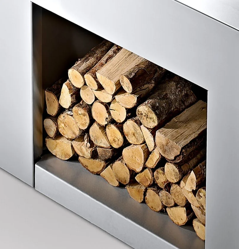 Close-up of the integrated log store beside the fire.