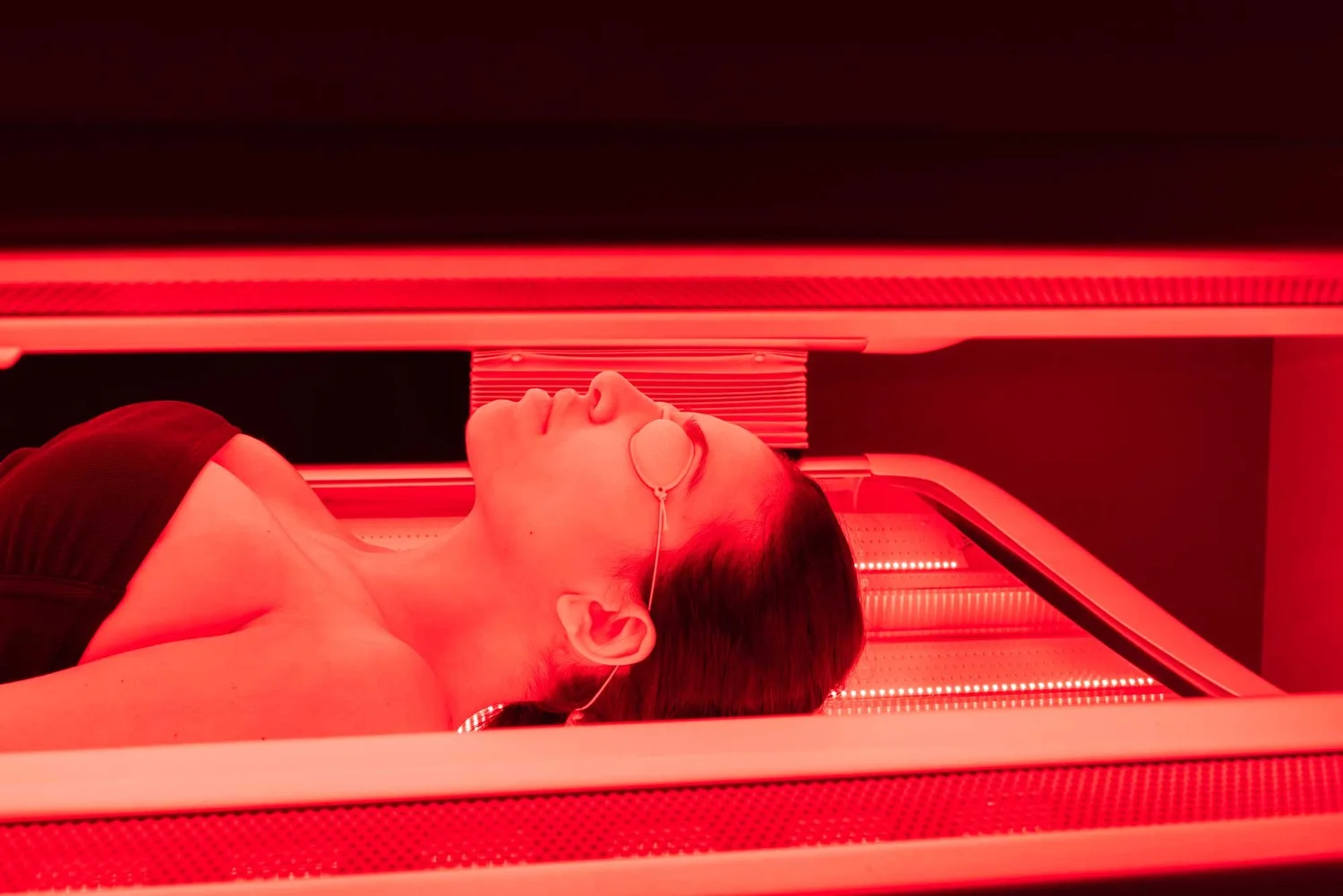 A beem® member in a red light therapy bed