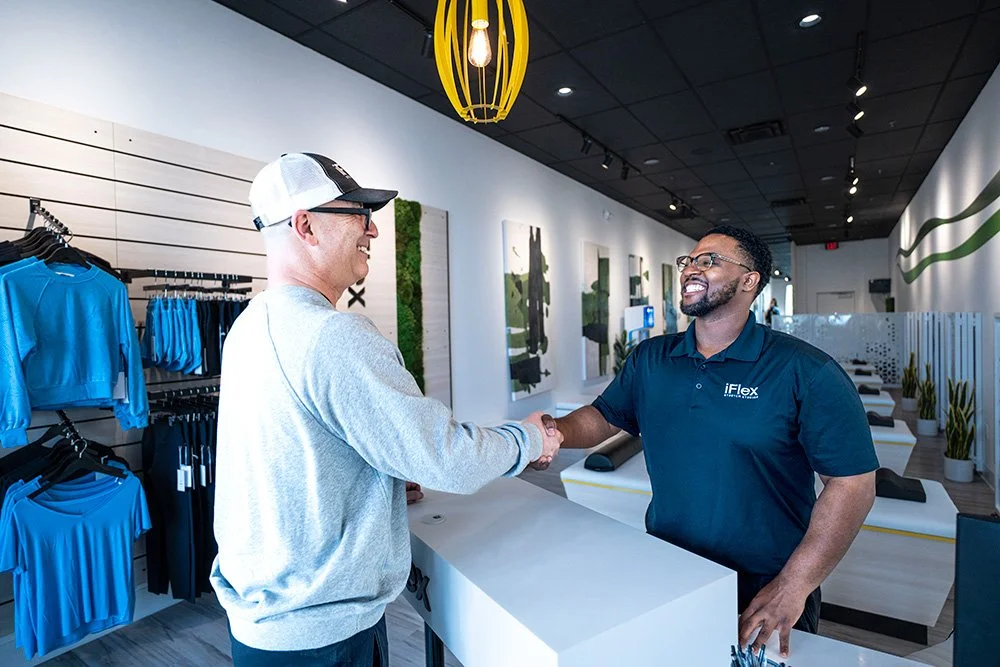 An iFlex Stretch Specialist working with a member