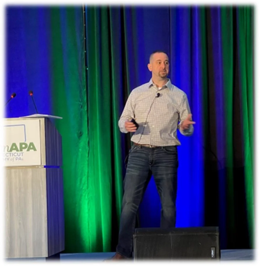Chris Marciano speaking on stage at a professional conference