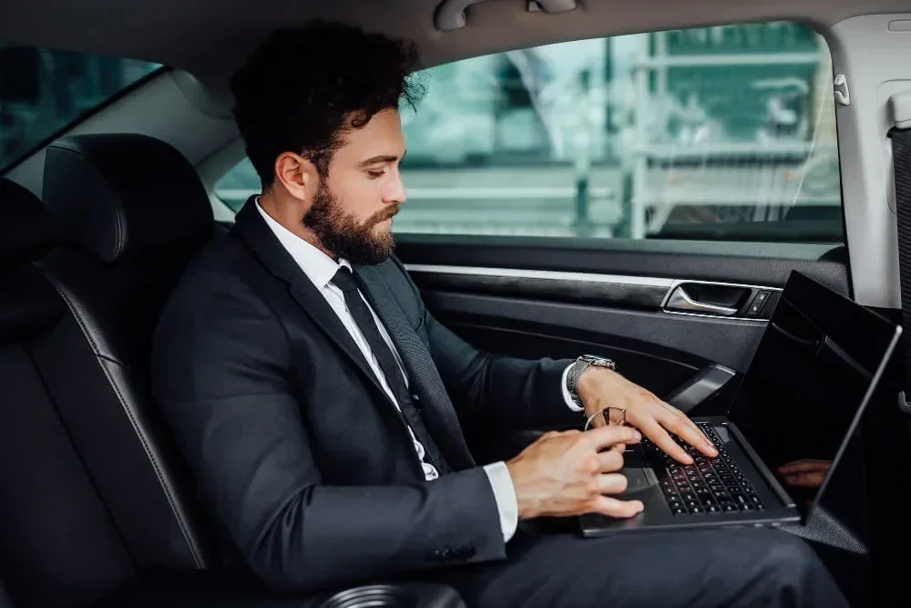 Corporate passenger working in a luxury vehicle
