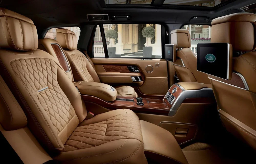 Luxury chauffeur interior with champagne leather and walnut trim on Oahu
