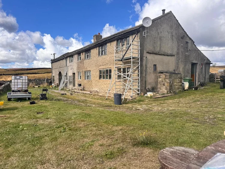 Springhead Lane property during stonework repairs and lime repointing, with access equipment in place