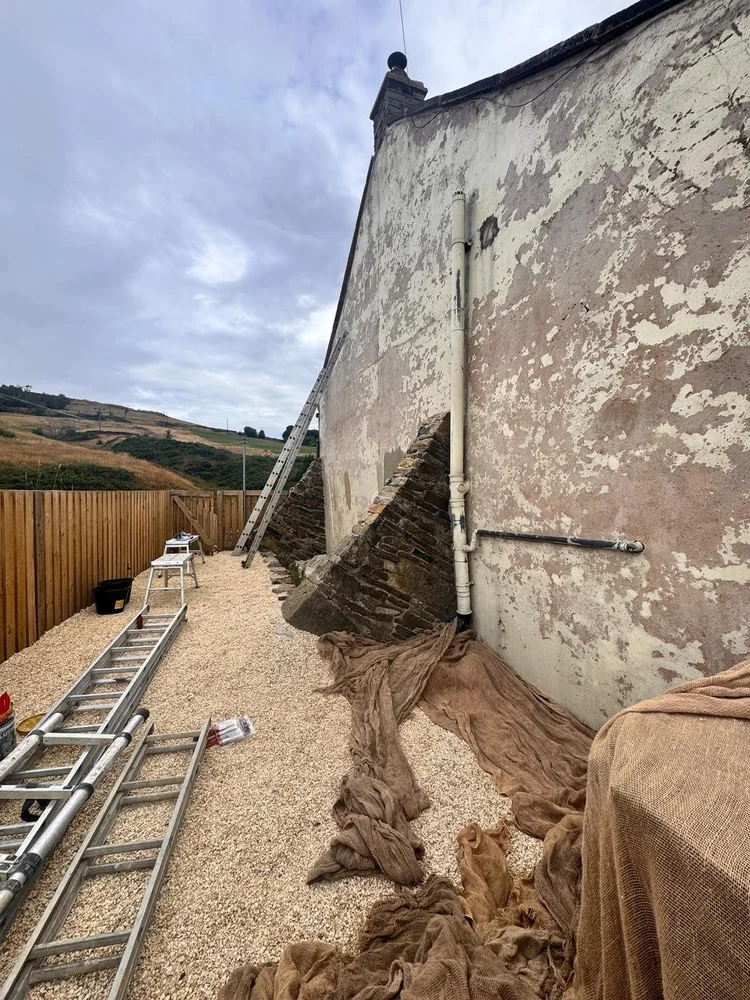 Close view of the Bolstermoor gable end during maintenance, with ladders and protective coverings