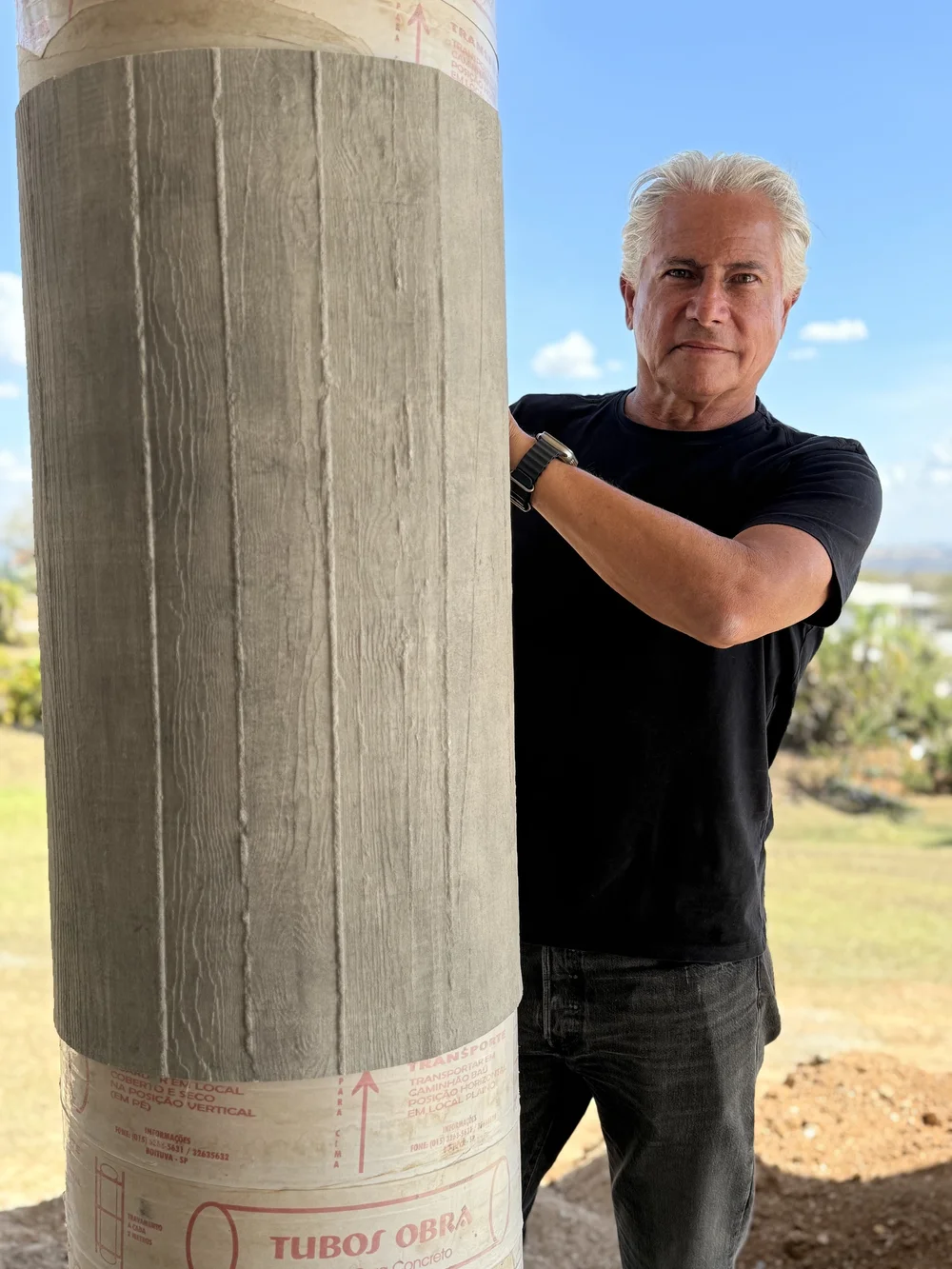 Paulo Pinheiro next to a column clad with Wall Skin