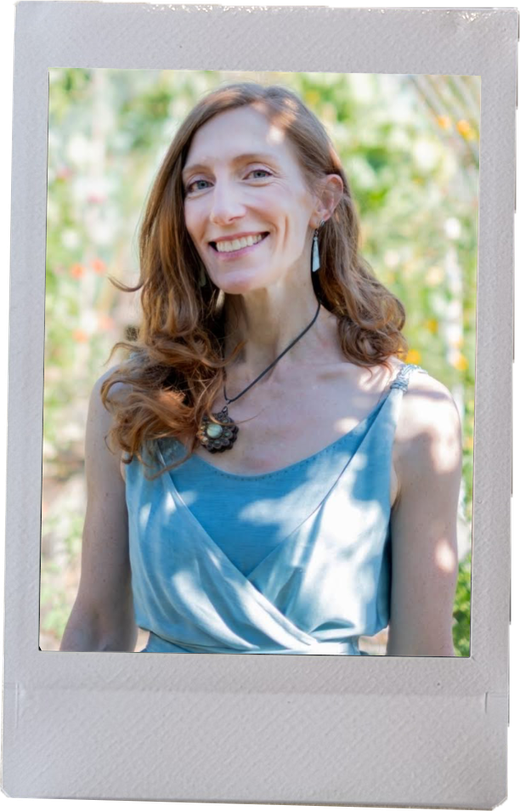 Regina Hunt smiling in a blue wrap top in front of a flower garden