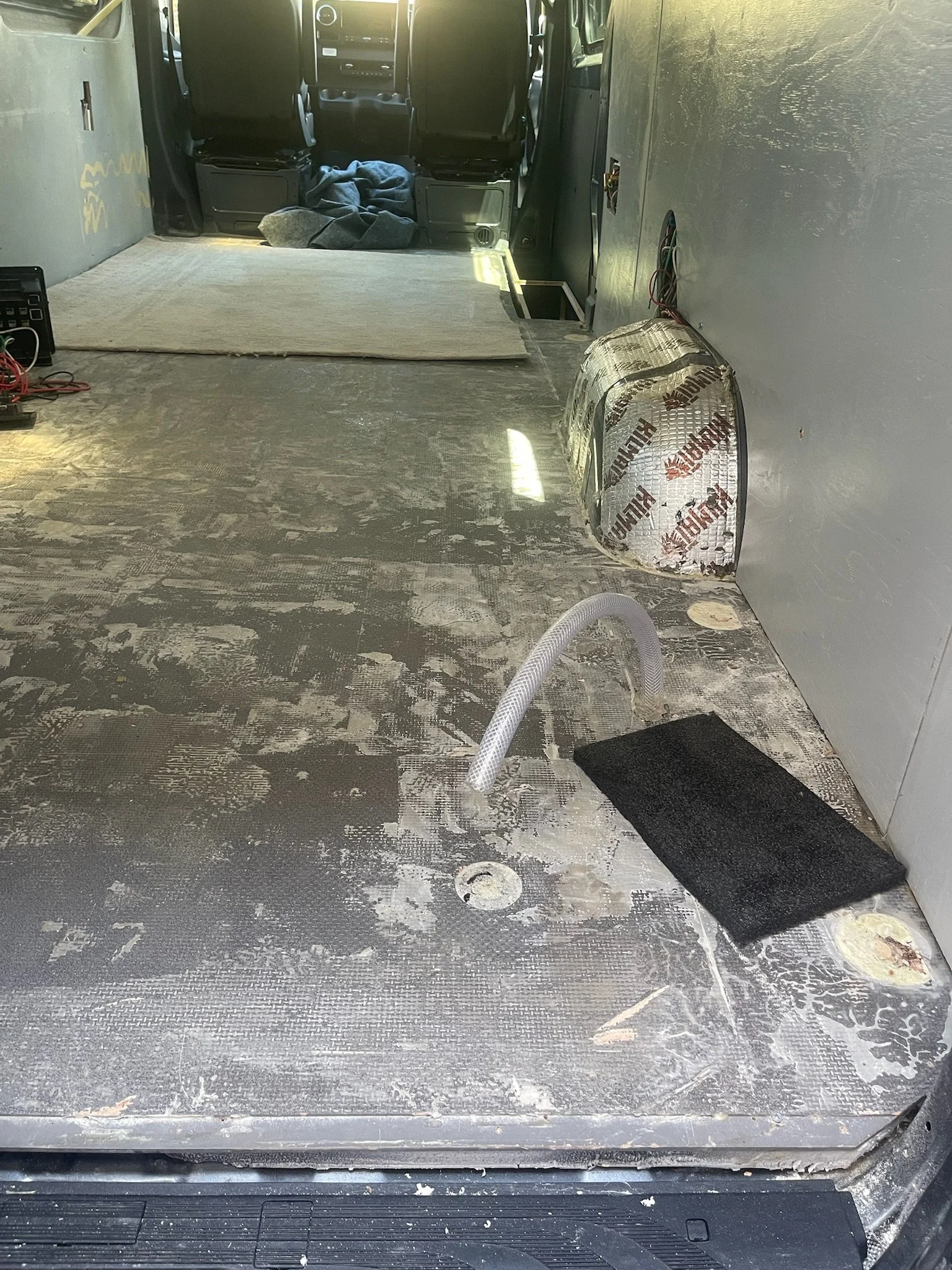 Grumley before — flooring removed back to bare van